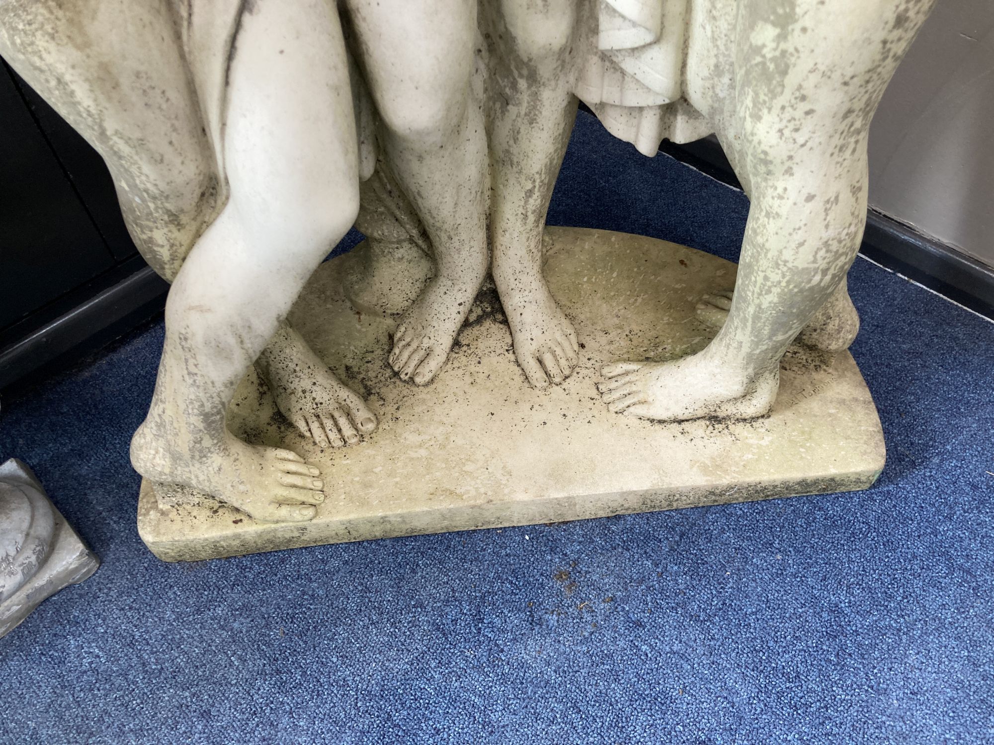A cast stone garden ornament modelled as the Three Graces, height 106cm